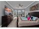 Spacious main bedroom with lake views and exercise equipment, featuring plush carpet and tray ceilings at 2770 Windsorgate Ln, Orlando, FL 32828