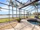 Relaxing screened-in pool and spa with a lake view, offering a serene and private oasis for outdoor enjoyment at 2770 Windsorgate Ln, Orlando, FL 32828
