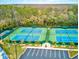 Aerial view of multiple tennis courts featuring lush green surroundings and convenient parking at 2770 Windsorgate Ln, Orlando, FL 32828