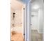 Modern bathroom featuring marble tile, updated fixtures, and a soaking tub with a rainfall shower head at 3028 Parkway Blvd # 105, Kissimmee, FL 34747
