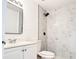 Modern bathroom featuring updated vanity, toilet, stylish mirror, and marble tiled shower at 3028 Parkway Blvd # 105, Kissimmee, FL 34747
