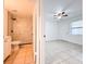 This combination image shows an updated bathroom and a bedroom with neutral tile flooring at 3028 Parkway Blvd # 105, Kissimmee, FL 34747