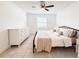 Bedroom with ceiling fan, tiled floor, and generous natural light at 3028 Parkway Blvd # 105, Kissimmee, FL 34747