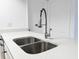 Updated kitchen featuring stainless steel appliances, a large sink, and a sleek faucet at 3028 Parkway Blvd # 105, Kissimmee, FL 34747