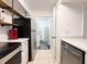 Galley kitchen features stainless appliances and access to the laundry room at 3028 Parkway Blvd # 105, Kissimmee, FL 34747