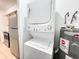 Convenient laundry area with stacked washer/dryer, adjacent to the kitchen with ample storage at 3028 Parkway Blvd # 105, Kissimmee, FL 34747