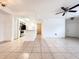 Inviting living room with an open layout, tile floors, and a view of the updated kitchen at 3028 Parkway Blvd # 105, Kissimmee, FL 34747