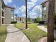 Scenic view of buildings with a pond, walkways, and lush green landscaping, perfect for relaxation at 3028 Parkway Blvd # 105, Kissimmee, FL 34747