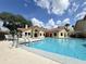 Community pool with inviting clear blue water and adjacent clubhouse, perfect for recreation at 3028 Parkway Blvd # 105, Kissimmee, FL 34747