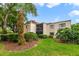 Exterior view of the home with tropical landscaping and a blue sky at 3294 S Semoran Blvd # 14, Orlando, FL 32822