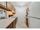 Efficient kitchen space with essential appliances, light countertops, and wood cabinets, offering a practical layout at 3294 S Semoran Blvd # 14, Orlando, FL 32822