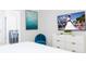 Bright bedroom with modern decor, including a TV, sleek dresser, and ensuite bathroom access at 3413 Lilac, Davenport, FL 33897