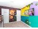 The bedroom features colorful cartoon mural on the walls, an entertainment center, and two white doors at 3413 Lilac, Davenport, FL 33897