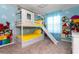 The bedroom features a bunk bed with a slide and colorful cartoon mural on the walls at 3413 Lilac, Davenport, FL 33897