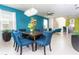 Bright dining room featuring a modern chandelier and an open floor plan that connects to the kitchen at 3413 Lilac, Davenport, FL 33897