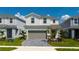 Charming two-story home with a paver driveway, attached two-car garage, and beautifully landscaped front yard at 3413 Lilac, Davenport, FL 33897