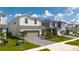 Street view of a two-story home with a paver driveway, attached two-car garage, and manicured lawn at 3413 Lilac, Davenport, FL 33897
