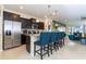 Modern kitchen with granite countertops, stainless steel appliances, dark cabinets, and a breakfast bar at 3413 Lilac, Davenport, FL 33897
