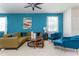 Stylish living room with a blue accent wall, comfortable seating, and a bright, airy atmosphere at 3413 Lilac, Davenport, FL 33897