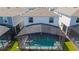 Aerial view of the private screened-in pool with lounge chairs and a covered patio area at 3413 Lilac, Davenport, FL 33897