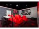 Home theater boasts a large screen, comfortable seating, and stylish, themed decor at 3413 Lilac, Davenport, FL 33897