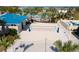 Outdoor beach volleyball court surrounded by palm trees and lush landscaping at 3413 Lilac, Davenport, FL 33897