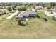 Expansive lawn surrounds this single story home with patio and mature landscaping at 4037 Se 40Th St, Ocala, FL 34480