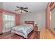 Bedroom with cherry wood flooring, window, ceiling fan, and furniture at 4037 Se 40Th St, Ocala, FL 34480