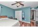 Bedroom with cherry wood flooring, double door closet, ceiling fan, and window at 4037 Se 40Th St, Ocala, FL 34480