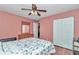 Bedroom featuring wood floors, a ceiling fan, a double door closet, and a dresser with mirror at 4037 Se 40Th St, Ocala, FL 34480