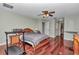 Bedroom featuring hardwood floors, ceiling fan, and light green painted walls at 4037 Se 40Th St, Ocala, FL 34480
