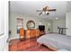 Bedroom with hardwood floors, ceiling fan, and a light green painted wall at 4037 Se 40Th St, Ocala, FL 34480