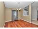 Classic dining room with gleaming hardwood floors, neutral walls, and elegant chandelier at 4037 Se 40Th St, Ocala, FL 34480