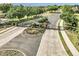 Gated community entrance with brick pillars, lush landscaping, and paved access road at 4037 Se 40Th St, Ocala, FL 34480
