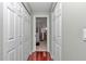 Hallway featuring hardwood floors and white closet doors at 4037 Se 40Th St, Ocala, FL 34480