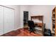 Home office featuring hardwood floors, natural wood desk, white walls, and a white closet door at 4037 Se 40Th St, Ocala, FL 34480