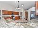Spacious kitchen with wooden cabinetry, granite countertops, and stainless-steel appliances at 4037 Se 40Th St, Ocala, FL 34480