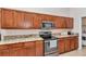 Kitchen featuring granite countertops, stainless steel appliances, and wooden cabinets at 4037 Se 40Th St, Ocala, FL 34480