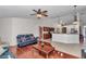 Open living room with hardwood floors, ceiling fan, and view of the kitchen at 4037 Se 40Th St, Ocala, FL 34480