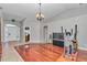 Spacious living room showcasing hardwood floors, a modern chandelier, and an open layout at 4037 Se 40Th St, Ocala, FL 34480