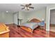 Bright main bedroom with hardwood floors, ceiling fan, and neutral paint scheme at 4037 Se 40Th St, Ocala, FL 34480