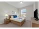 Comfortable bedroom featuring a queen bed and a view of the community through the window at 4102 Breakview Dr # 30603, Orlando, FL 32819