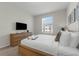 Bright bedroom featuring a queen bed and a view of the community through the window at 4102 Breakview Dr # 30603, Orlando, FL 32819
