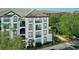 Multi-level condo building with balconies and mature trees, offering a blend of comfort and natural beauty at 4102 Breakview Dr # 30603, Orlando, FL 32819