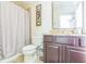 Neutral toned bathroom with a granite countertop, tile floors and shower-tub combination at 442 Anessa Rose Loop, Ocoee, FL 34761