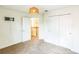 Clean bedroom with carpet flooring, a closet, and open doorway to the hallway at 442 Anessa Rose Loop, Ocoee, FL 34761
