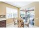 Cozy breakfast nook with a glass table and chairs, next to the outdoor patio at 442 Anessa Rose Loop, Ocoee, FL 34761