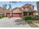 Charming two-story home with three-car garage, lush landscaping, and paver driveway offers curb appeal at 442 Anessa Rose Loop, Ocoee, FL 34761