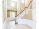 Elegant foyer with a staircase, tile flooring, neutral colors, and natural light creates a welcoming entrance at 442 Anessa Rose Loop, Ocoee, FL 34761