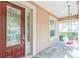 Charming front porch featuring a porch swing, decorative glass door and brick flooring, perfect for relaxing at 442 Anessa Rose Loop, Ocoee, FL 34761
